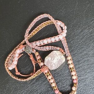 Pink and gold wrap bracelet with pink stone.
